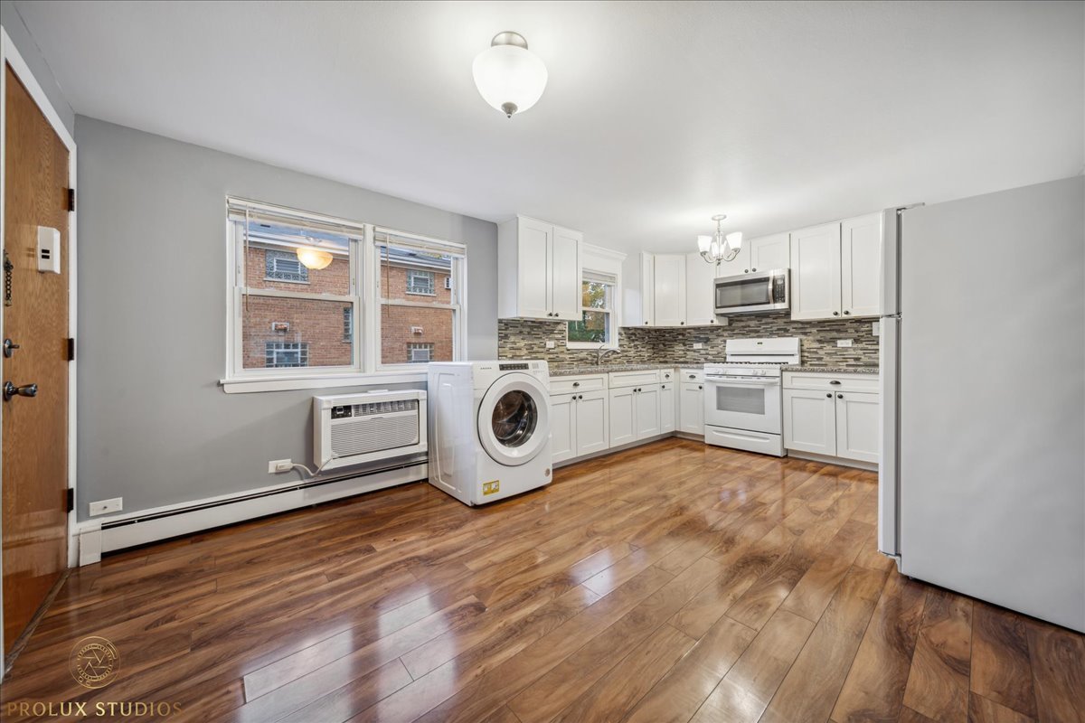 6935 West 64th Place, Unit 2A Chicago, IL 60638 - Photo 5 of 15 a kitchen with a stove a sink and a refrigerator