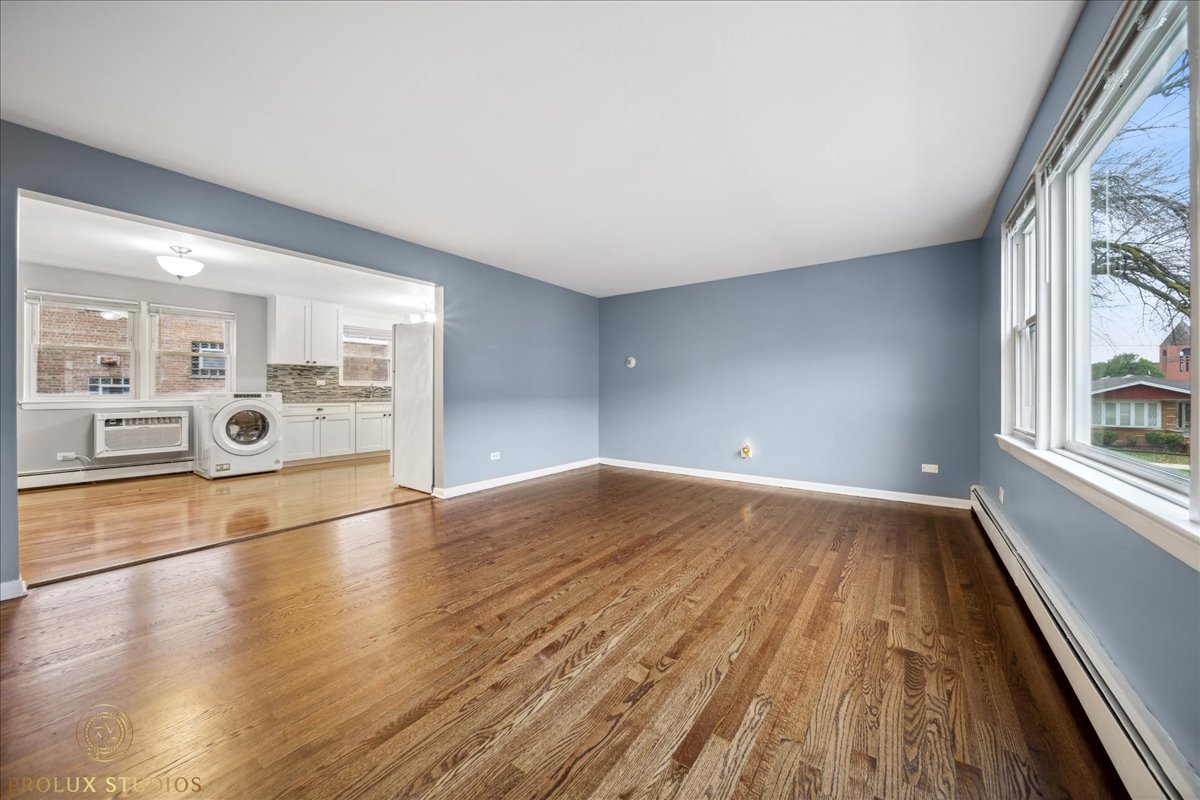 6935 West 64th Place, Unit 2A Chicago, IL 60638 - Photo 8 of 15 wooden floor in an empty room with a window