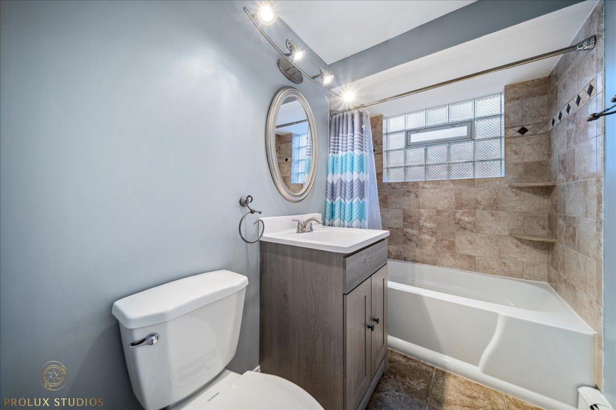 6935 West 64th Place, Unit 2A Chicago, IL 60638 - Photo 10 of 15 a bathroom with a sink toilet and shower