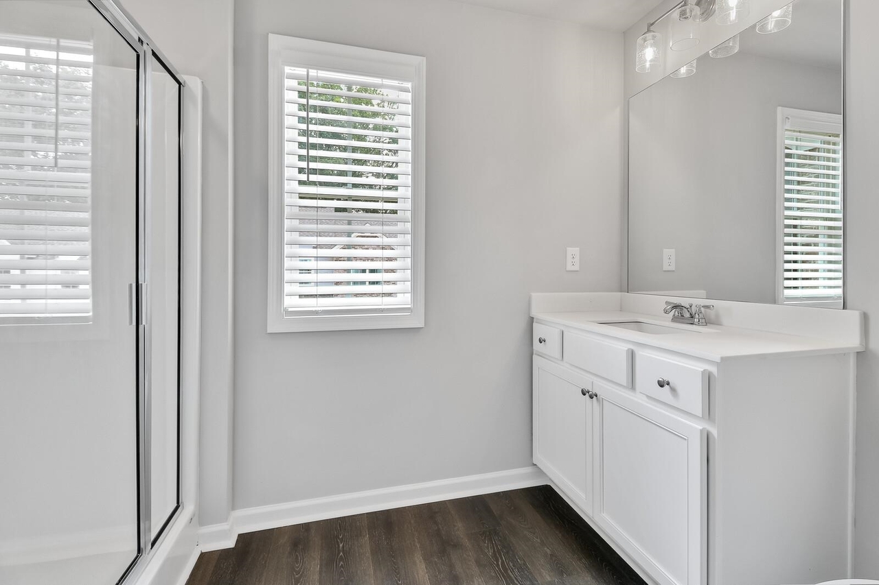 15 Sprayberry Road, Unit 11 Newnan, GA 30263 - Photo 13 of 18 a bathroom with a sink a vanity and a mirror