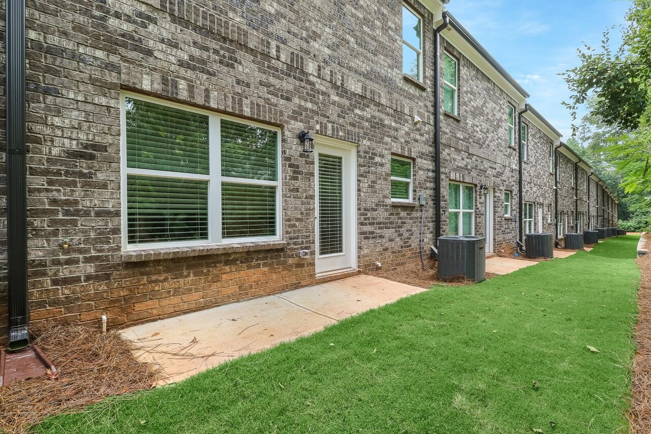15 Sprayberry Road, Unit 11 Newnan, GA 30263 - Photo 17 of 18 a view of a house with a yard and sitting area