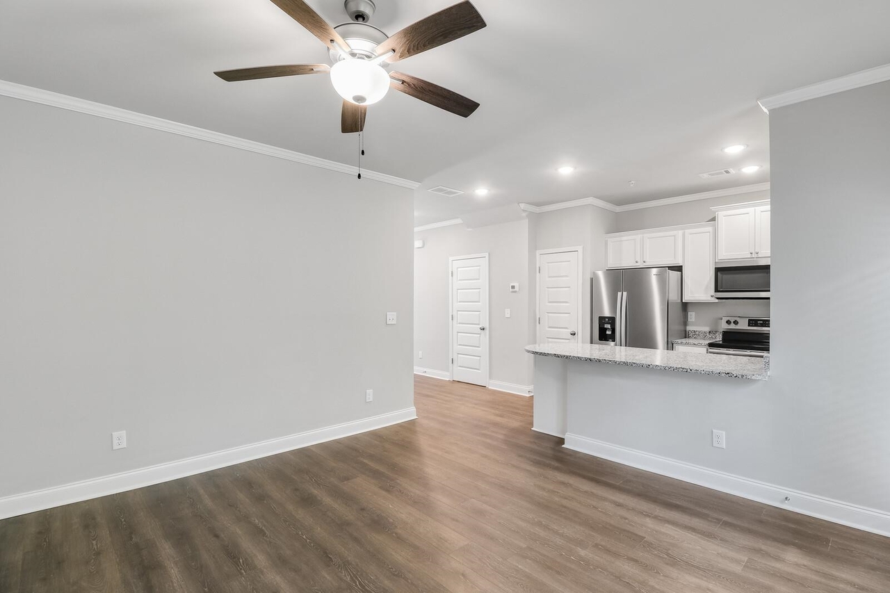 15 Sprayberry Road, Unit 11 Newnan, GA 30263 - Photo 5 of 18 a view of kitchen with stainless steel appliances refrigerator stove microwave and cabinets