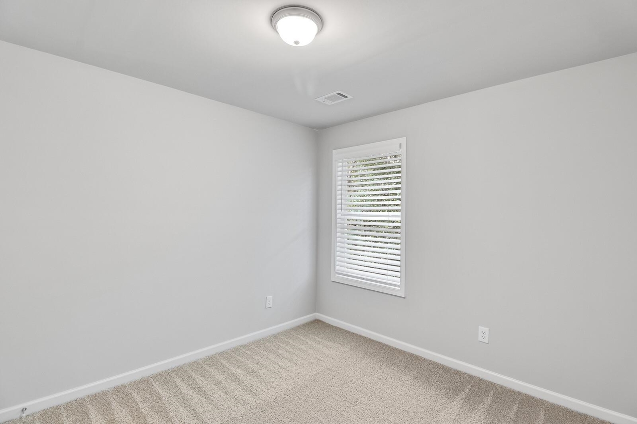 15 Sprayberry Road, Unit 11 Newnan, GA 30263 - Photo 8 of 18 an empty room with windows