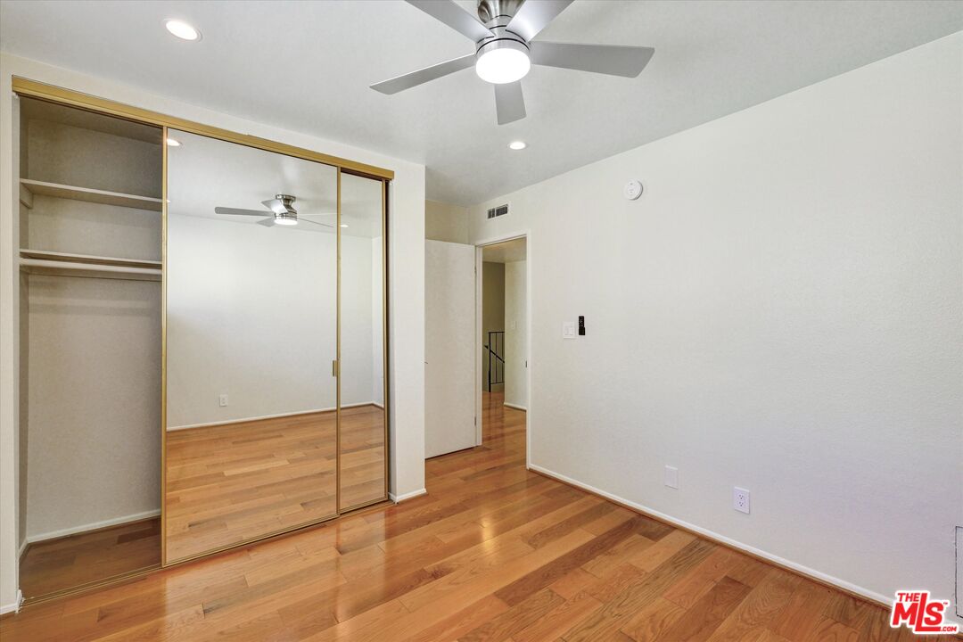 9634 Vía Rimini, Unit 118 Burbank, CA 91504 - Photo 14 of 35 a view of an empty room with wooden floor