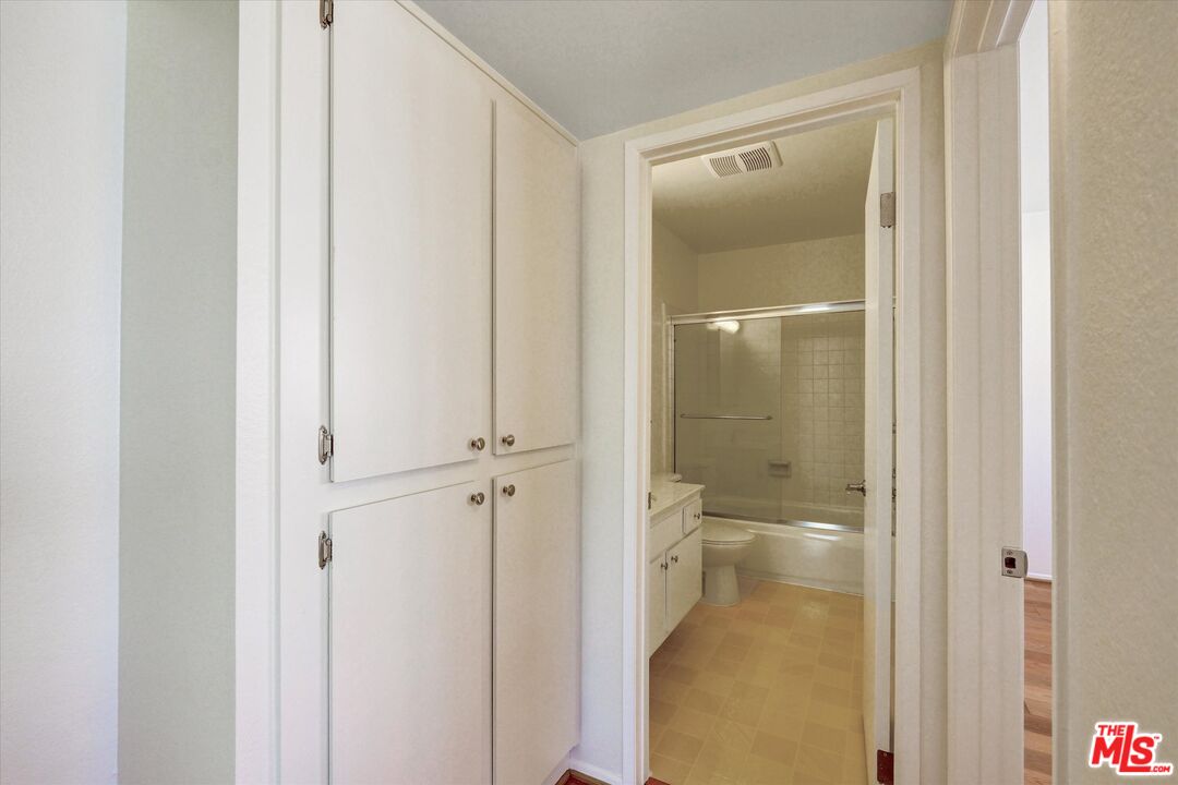 9634 Vía Rimini, Unit 118 Burbank, CA 91504 - Photo 15 of 35 a bathroom with a glass shower door