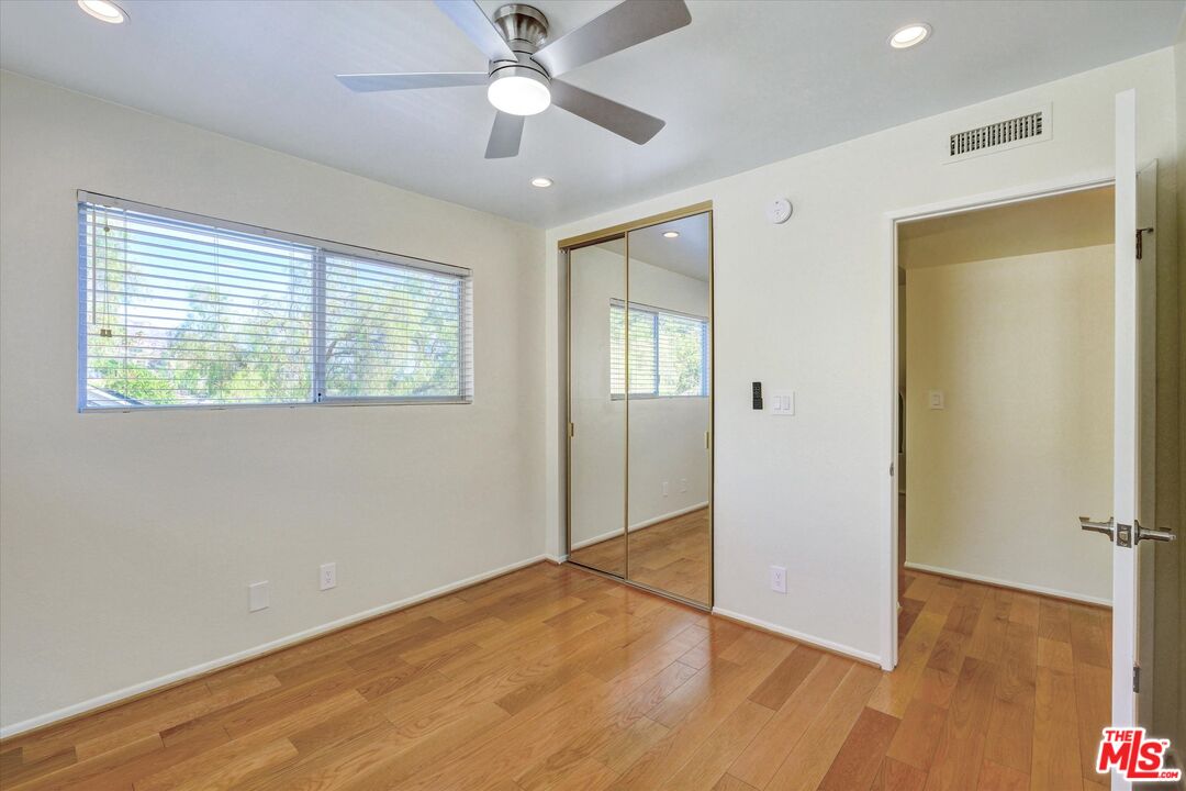 9634 Vía Rimini, Unit 118 Burbank, CA 91504 - Photo 19 of 35 a view of an empty room with wooden floor and a window