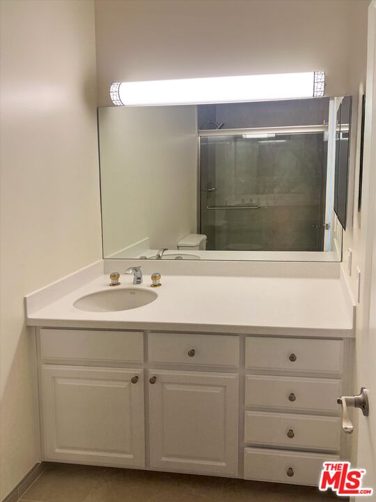 9634 Via Rimini, Unit 118 Sun Valley, CA 91504 - Photo 23 of 33 a bathroom with a sink and a mirror
