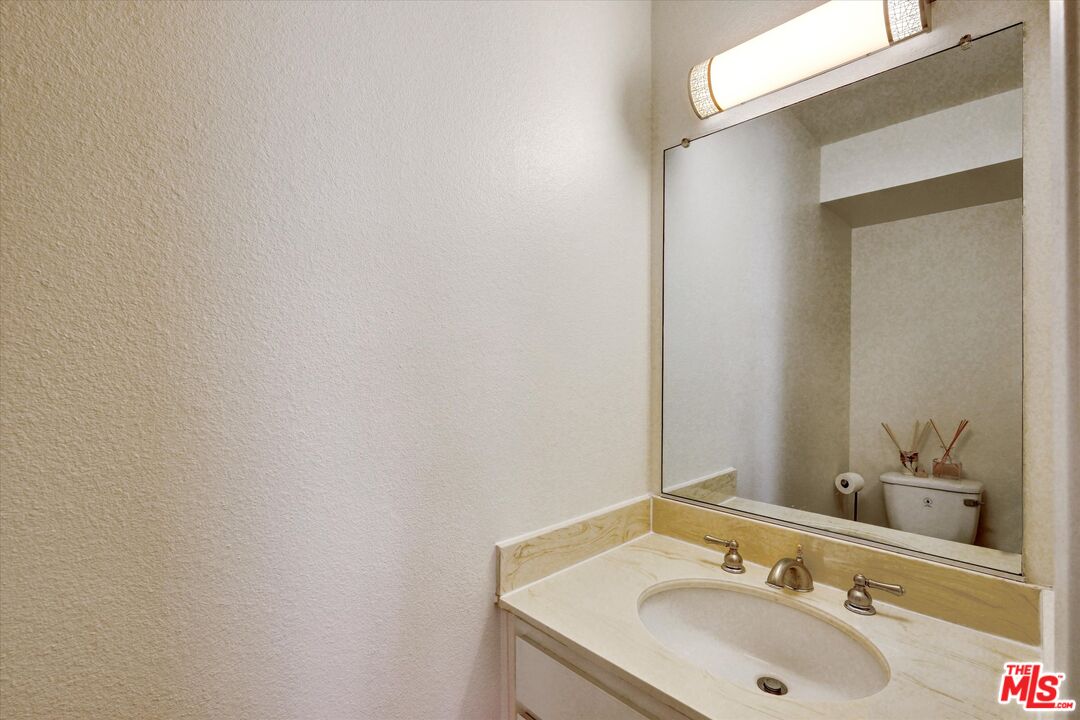 9634 Via Rimini, Unit 118 Sun Valley, CA 91504 - Photo 24 of 33 a bathroom with a sink and a mirror