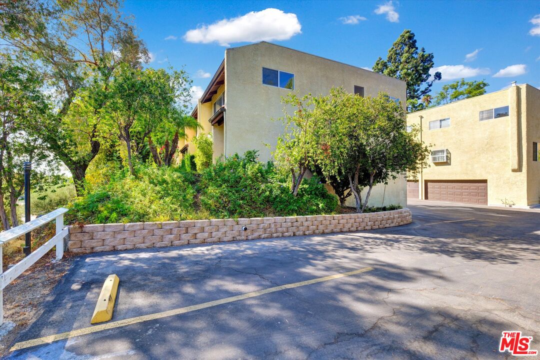 9634 Vía Rimini, Unit 118 Burbank, CA 91504 - Photo 34 of 35 a view of a house with a yard