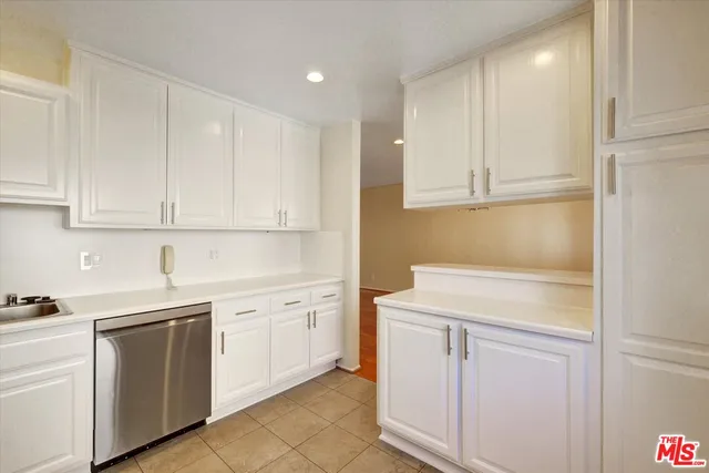 a kitchen with white cabinets