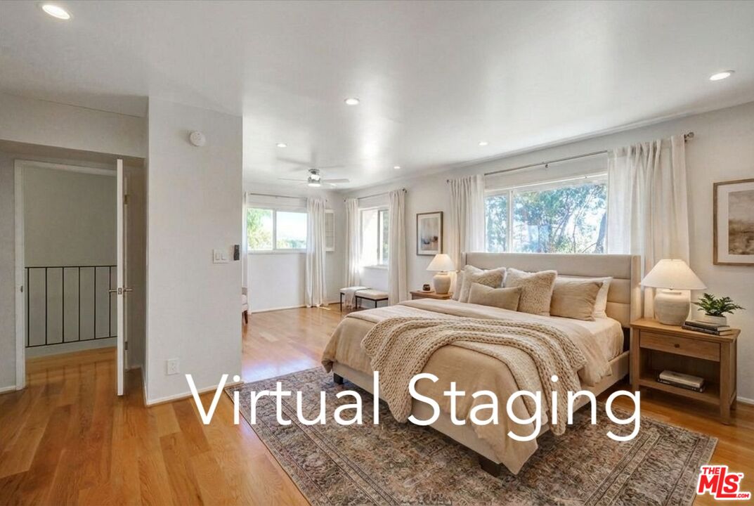 9634 Vía Rimini, Unit 118 Burbank, CA 91504 - Photo 9 of 35 a bedroom with a bed and wooden floor