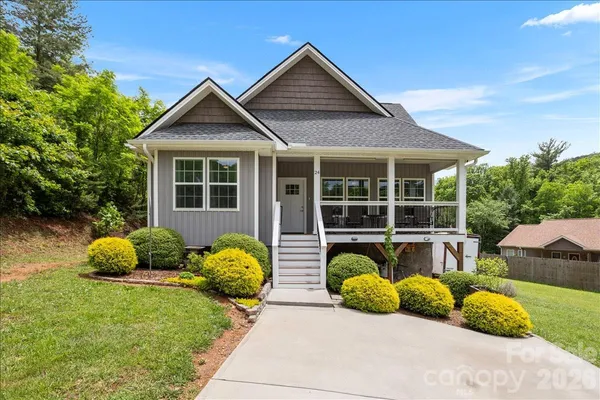 a front view of house with yard outdoor seating and green space
