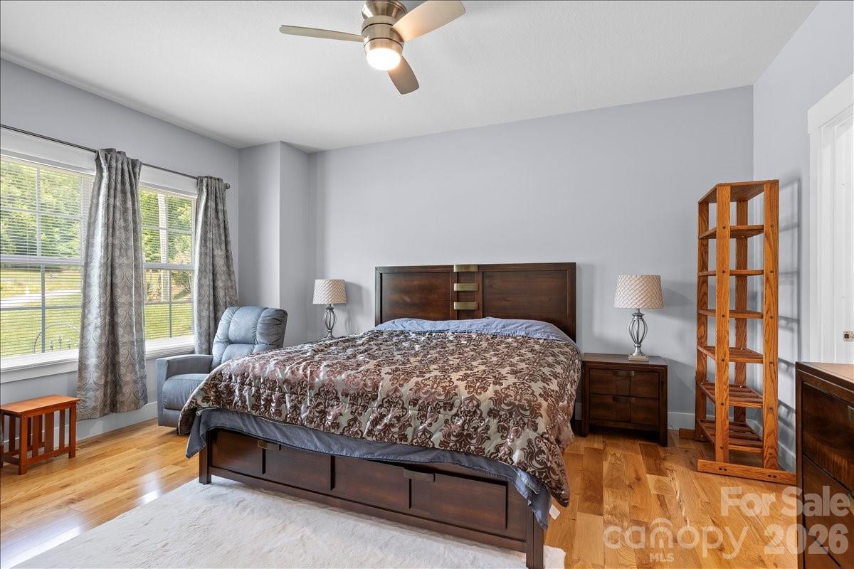 24 Mink Farm Road Leicester, NC 28748 - Photo 18 of 35 a bedroom with a bed and wooden floor