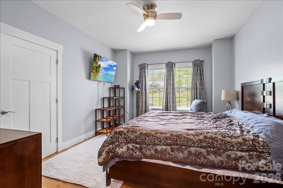 24 Mink Farm Road Leicester, NC 28748 - Photo 19 of 35 a bedroom with a bed and a dresser in it