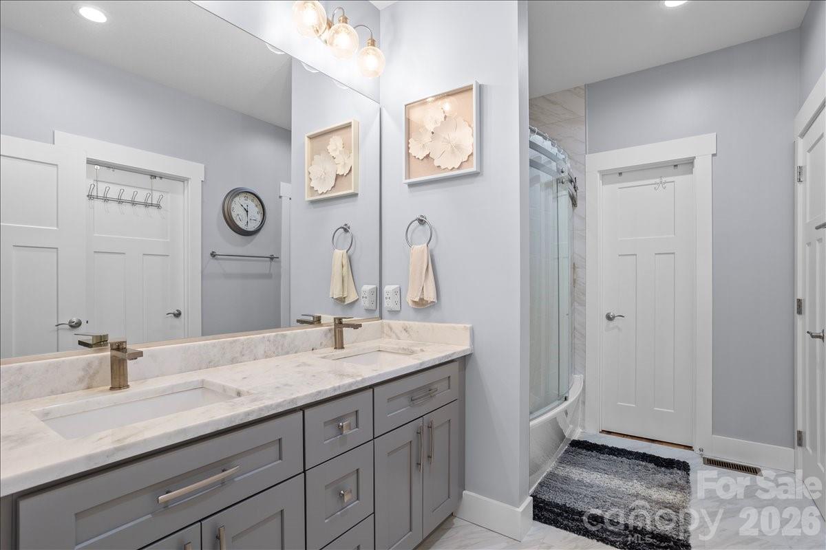 24 Mink Farm Road Leicester, NC 28748 - Photo 20 of 35 a bathroom with a double vanity sink and a mirror