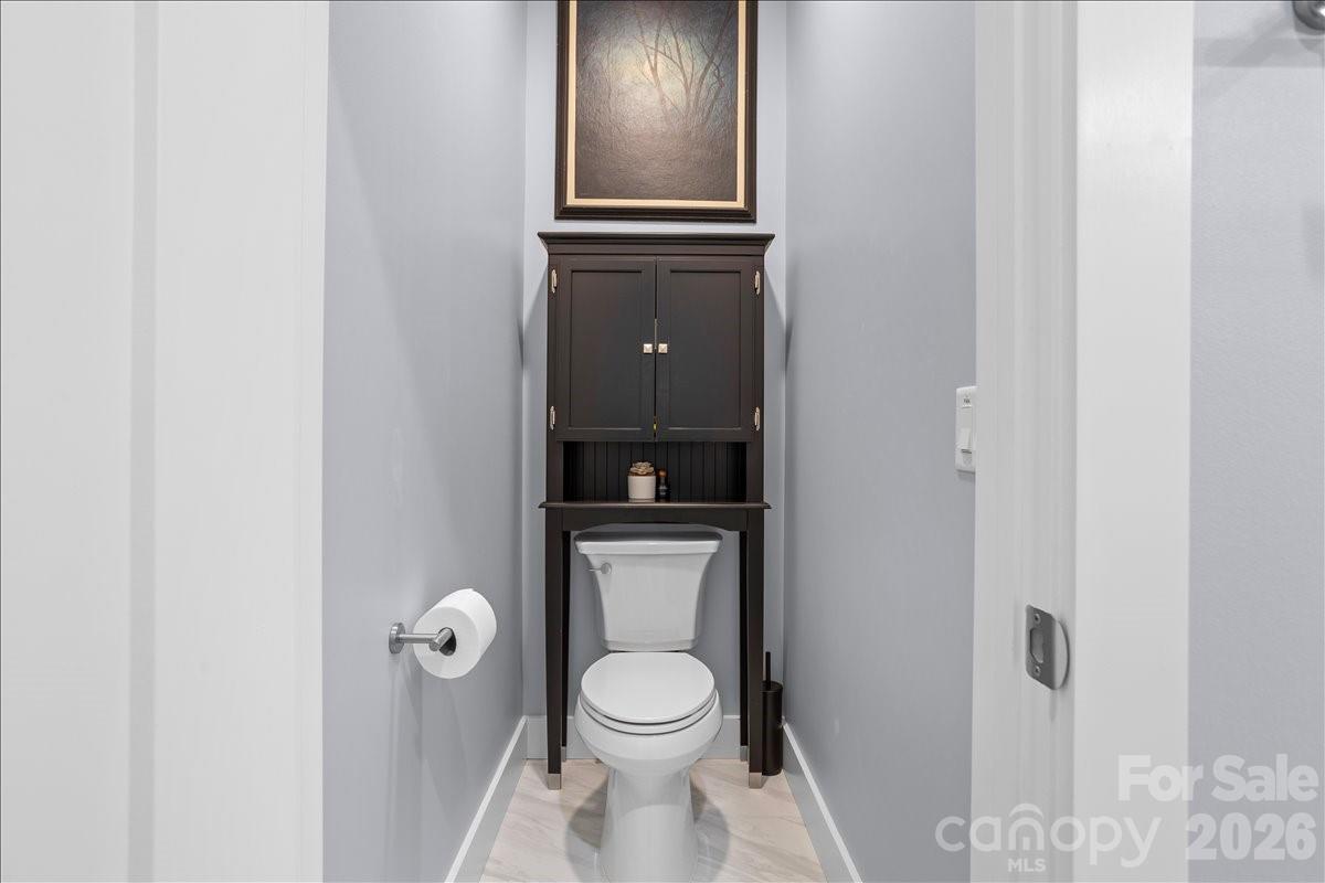 24 Mink Farm Road Leicester, NC 28748 - Photo 21 of 35 a white toilet sitting next to a bathroom sink