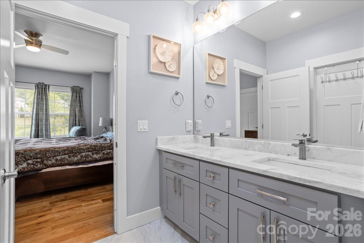 24 Mink Farm Road Leicester, NC 28748 - Photo 22 of 35 a en suite bathroom with double sink and a mirror
