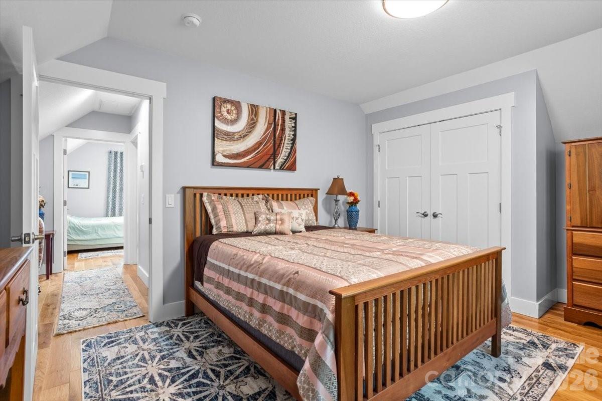 24 Mink Farm Road Leicester, NC 28748 - Photo 24 of 35 a bedroom with a bed and wooden floor