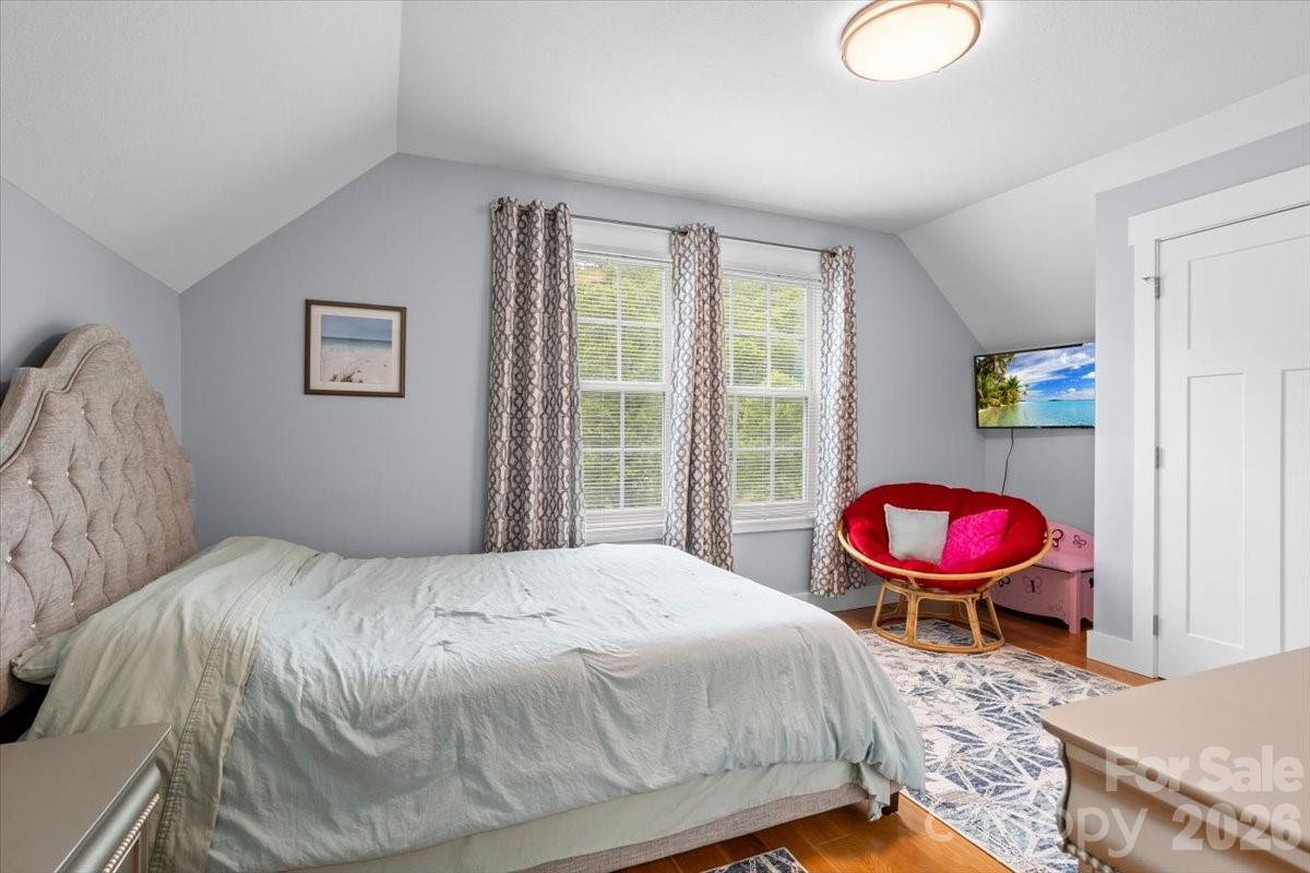24 Mink Farm Road Leicester, NC 28748 - Photo 27 of 35 a bedroom with a bed and wooden floor