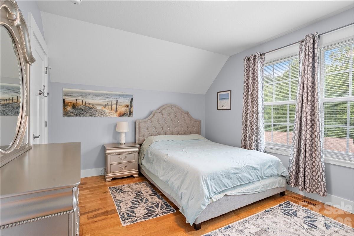 24 Mink Farm Road Leicester, NC 28748 - Photo 28 of 35 a bedroom with a bed lamp and a large window with outer view