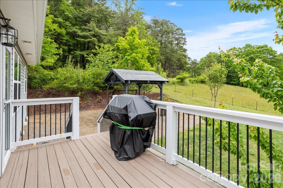 24 Mink Farm Road Leicester, NC 28748 - Photo 30 of 35 a view of a deck with furniture and wooden floor