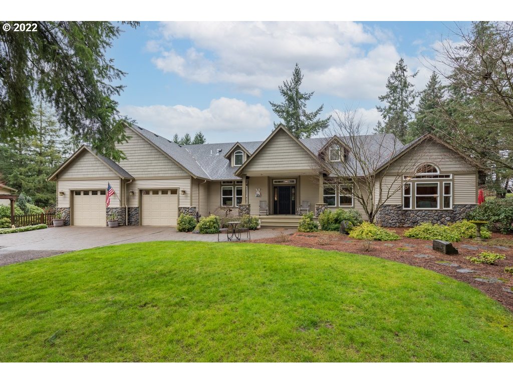 a front view of a house with yard patio and green space