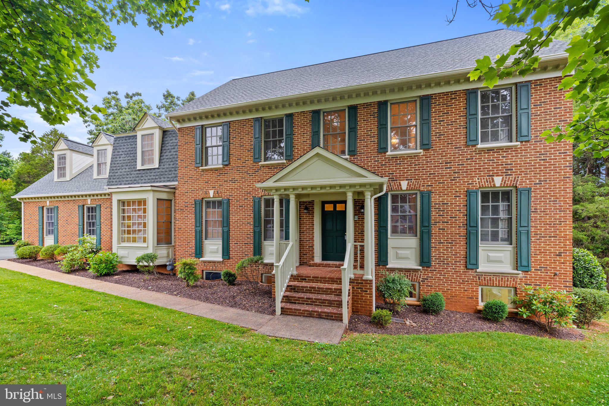 7589 Cannoneer Court Warrenton, VA 20186 - Photo 1 of 51 a front view of a house with garden and porch
