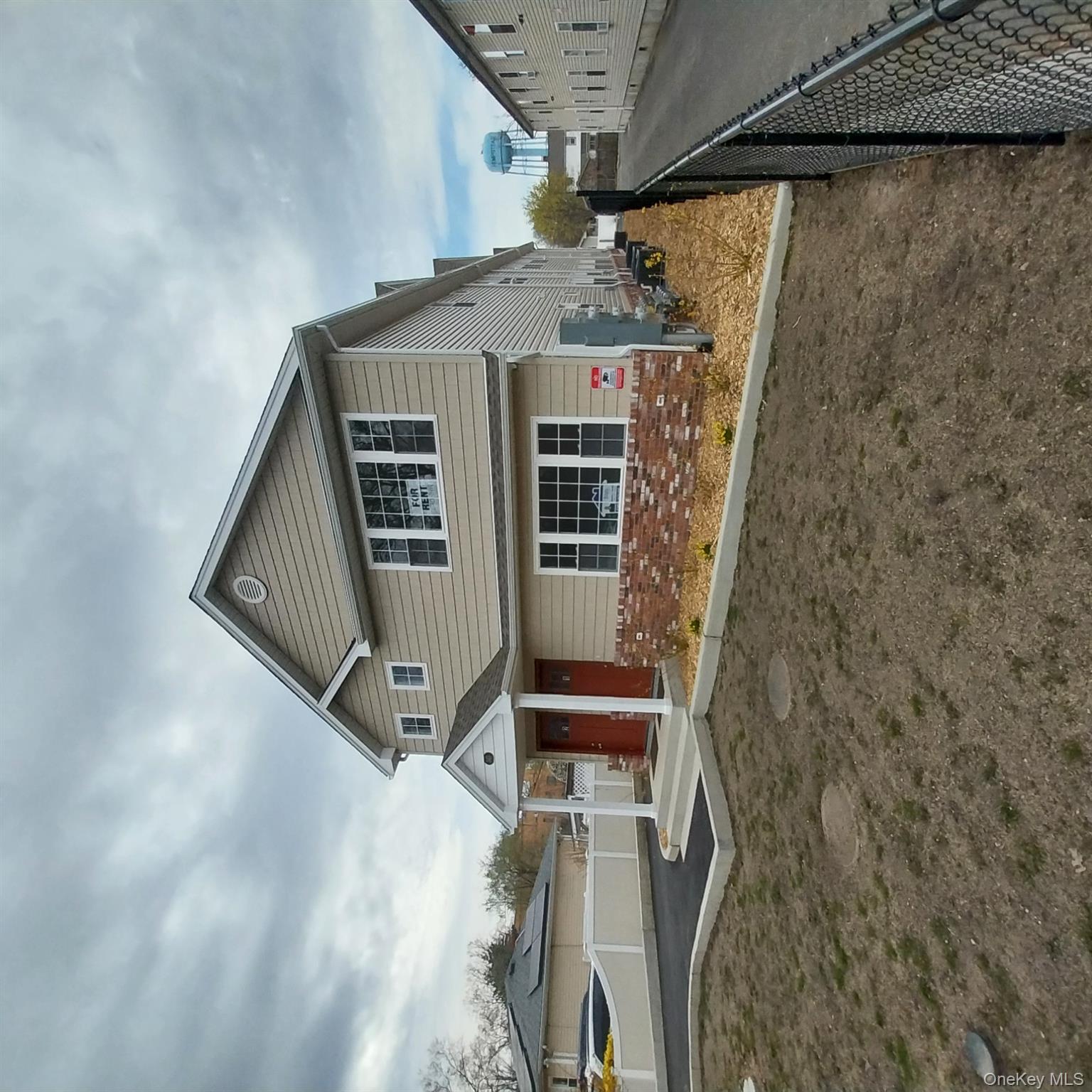 343 Jackson Street, Unit 3 Hempstead, NY 11550 - Photo 2 of 23 a front view of a house with a yard