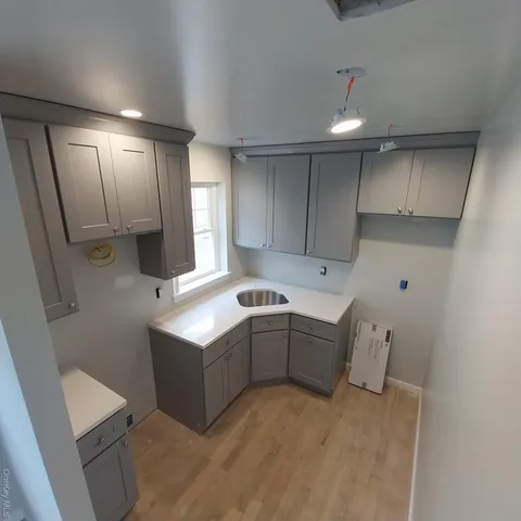 a kitchen with cabinets and window
