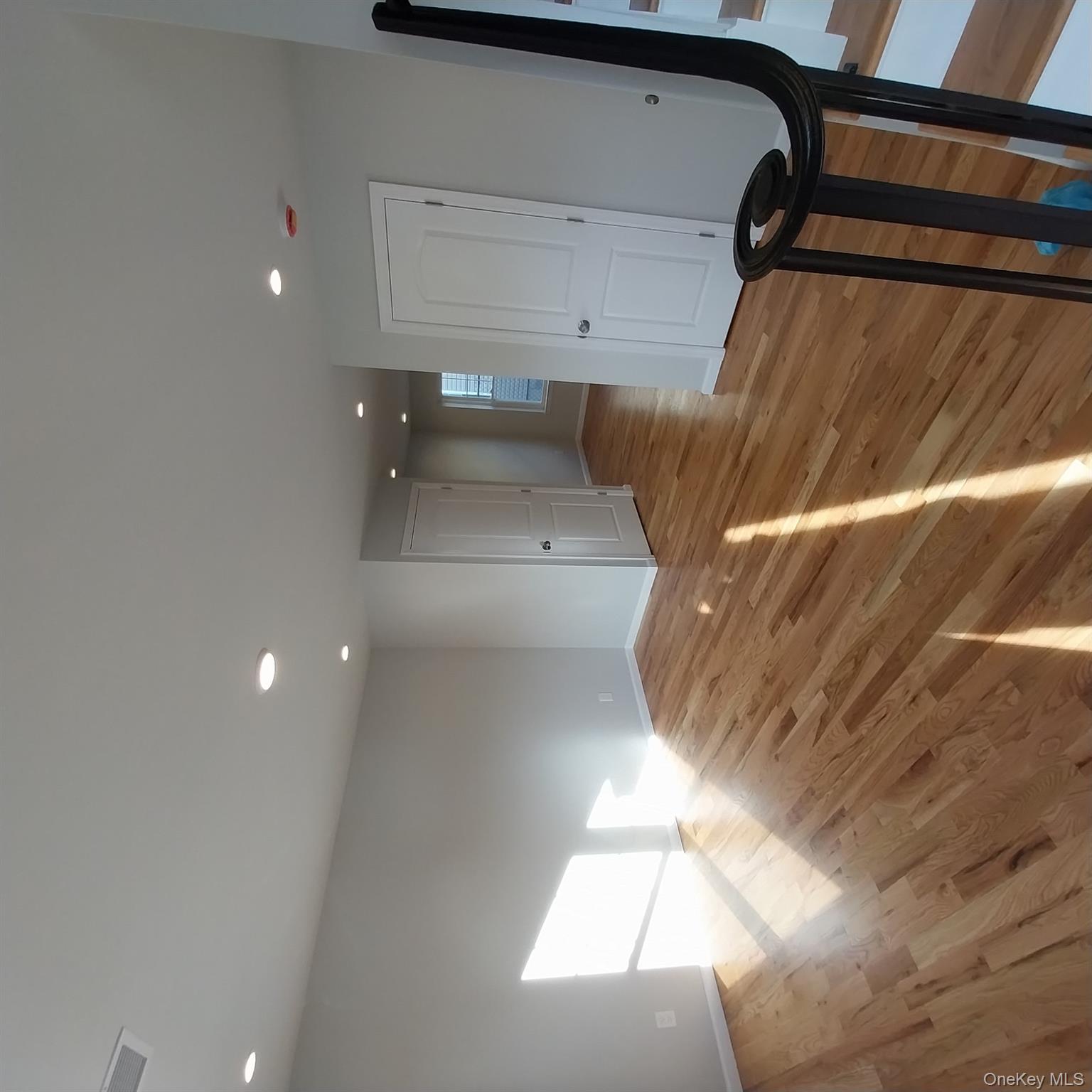 343 Jackson Street, Unit 3 Hempstead, NY 11550 - Photo 6 of 23 a view of empty room with wooden floor