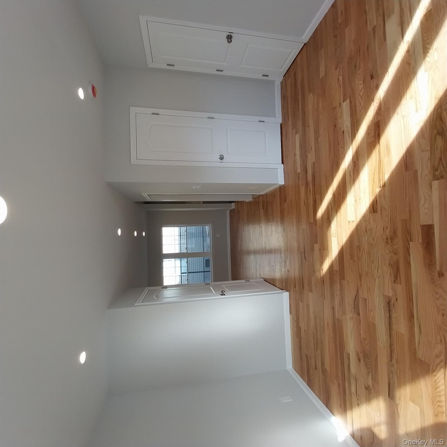 343 Jackson Street, Unit 3 Hempstead, NY 11550 - Photo 7 of 23 a view of empty room with wooden floor and fan
