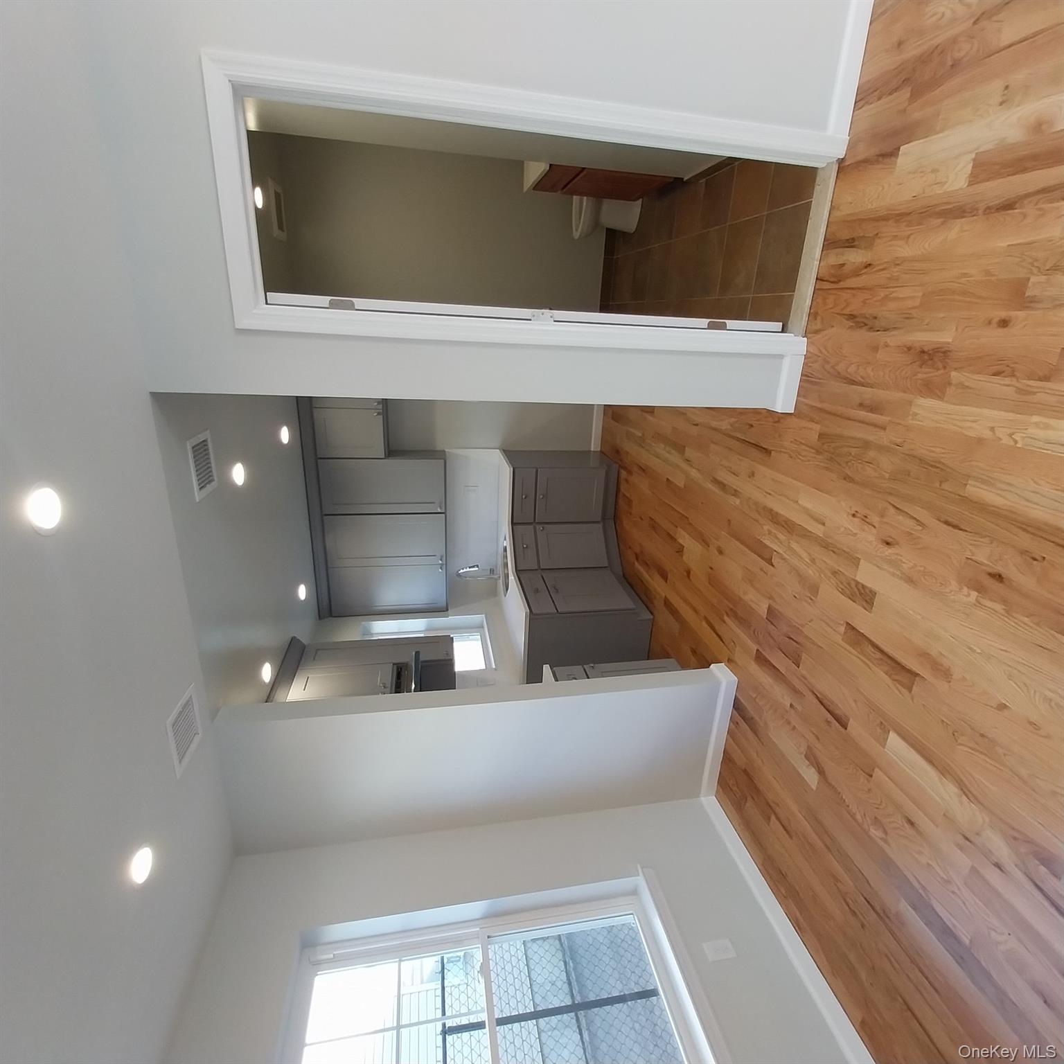 343 Jackson Street, Unit 3 Hempstead, NY 11550 - Photo 8 of 23 a view of a kitchen from the hallway