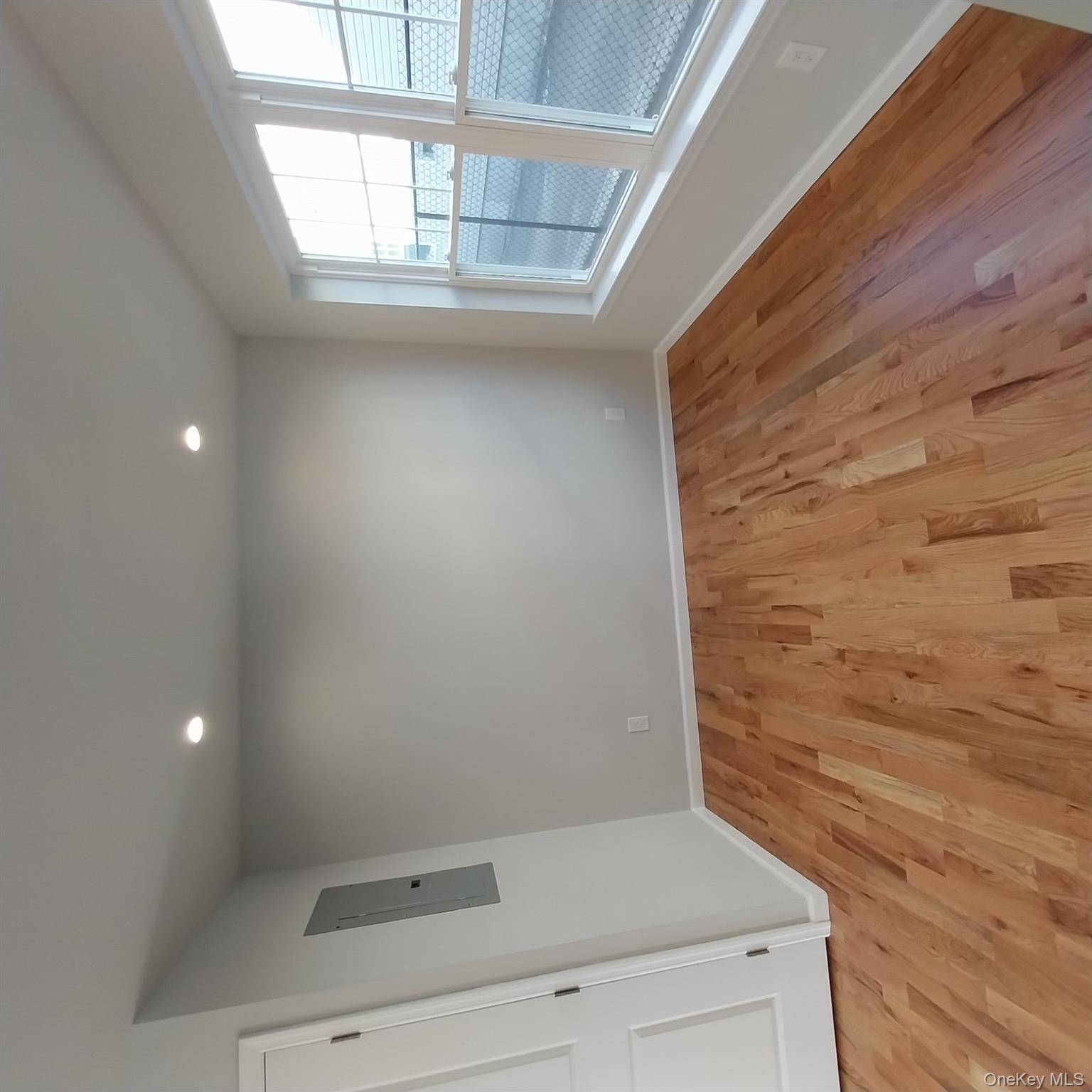 343 Jackson Street, Unit 3 Hempstead, NY 11550 - Photo 9 of 23 wooden floor in an empty room with a window