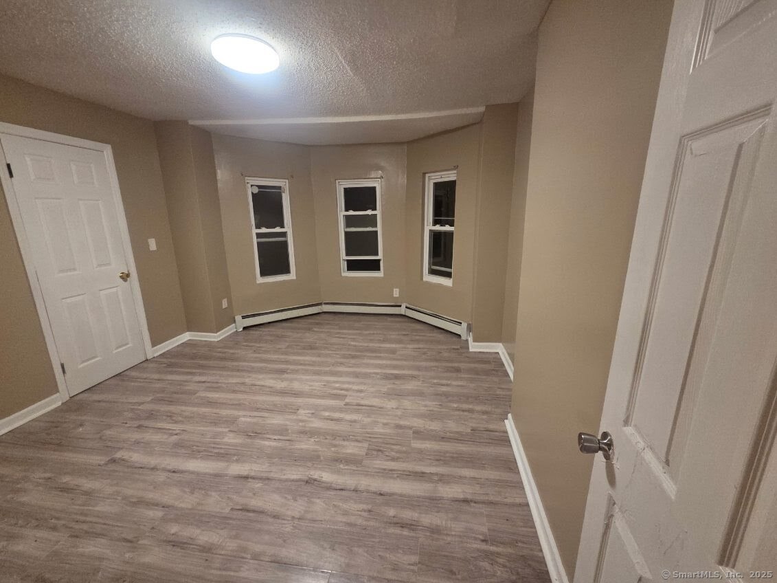 63 Seyms Street Hartford, CT 06120 - Photo 8 of 12 wooden floor in an empty room with a window