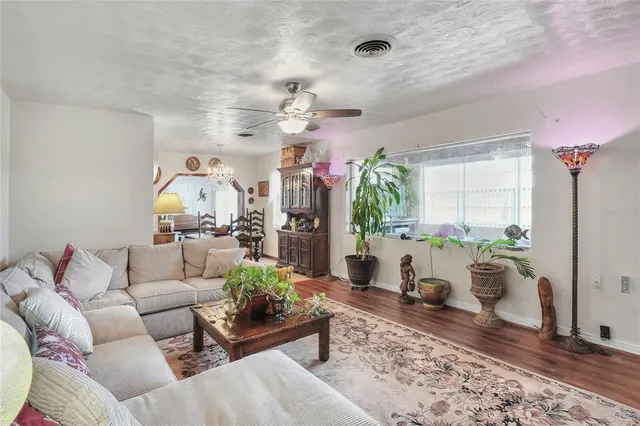 a living room with furniture a rug and a chandelier