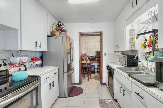 a kitchen with stainless steel appliances a stove and cabinets