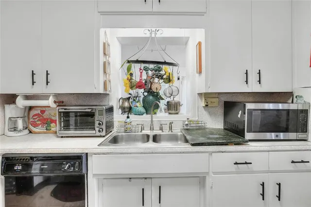 a kitchen with stainless steel appliances a stove sink and refrigerator