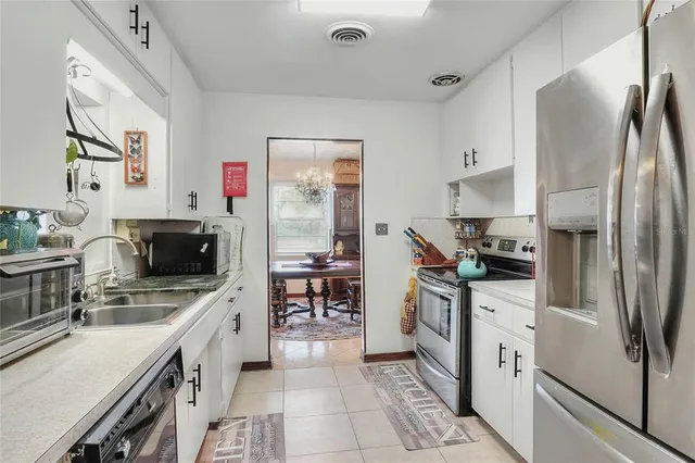 a view of a dining room with furniture and chandelier