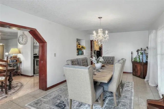 a view of a dining room with furniture and chandelier