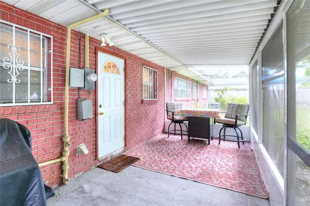 a front view of a house with a yard and potted plants