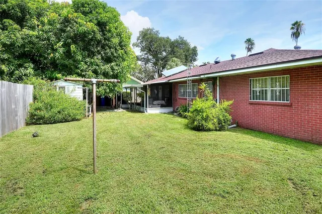 a view of a house with a yard and sitting area