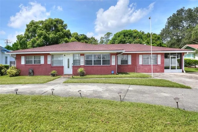 an aerial view of residential houses with outdoor space and trees