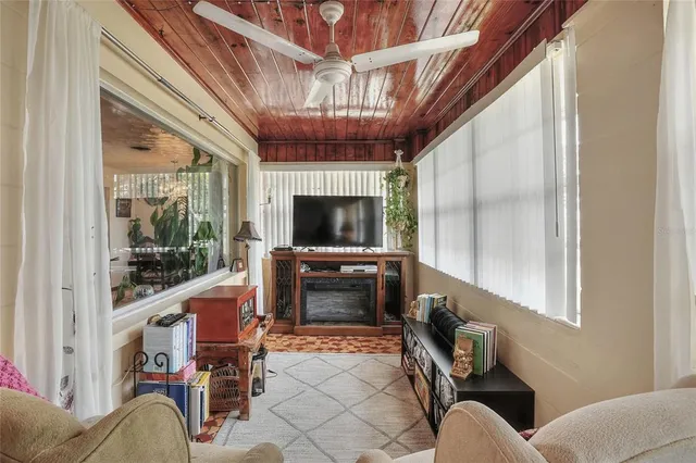 a living room with furniture and flowers