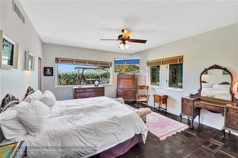 2102 Bay Drive Pompano Beach, FL 33062 - Photo 22 of 71 a bedroom with a bed large window with table and chairs