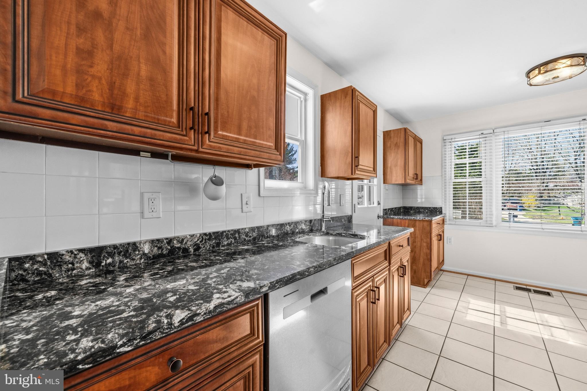 5 Coatbridge Court Olney, MD 20832 - Photo 12 of 49 a kitchen with stainless steel appliances granite countertop a sink stove and cabinets