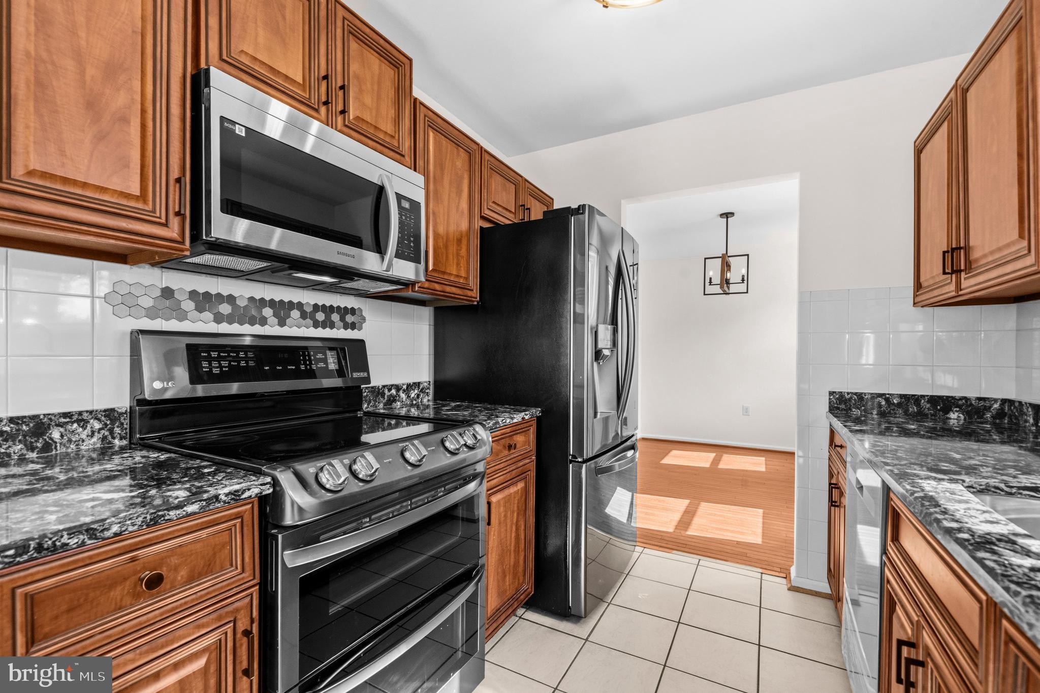 5 Coatbridge Court Olney, MD 20832 - Photo 14 of 49 a kitchen with stainless steel appliances granite countertop a stove microwave and refrigerator