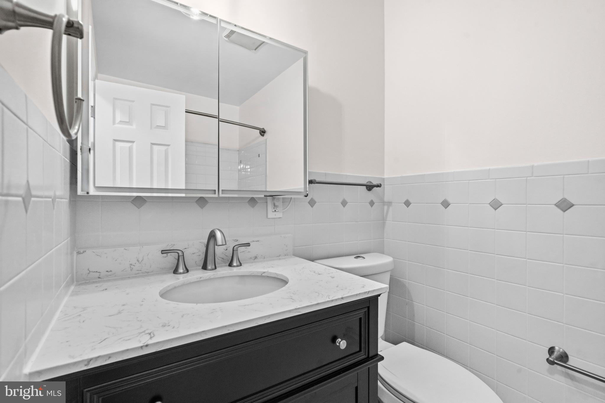 5 Coatbridge Court Olney, MD 20832 - Photo 25 of 49 a bathroom with a sink a toilet and vanity
