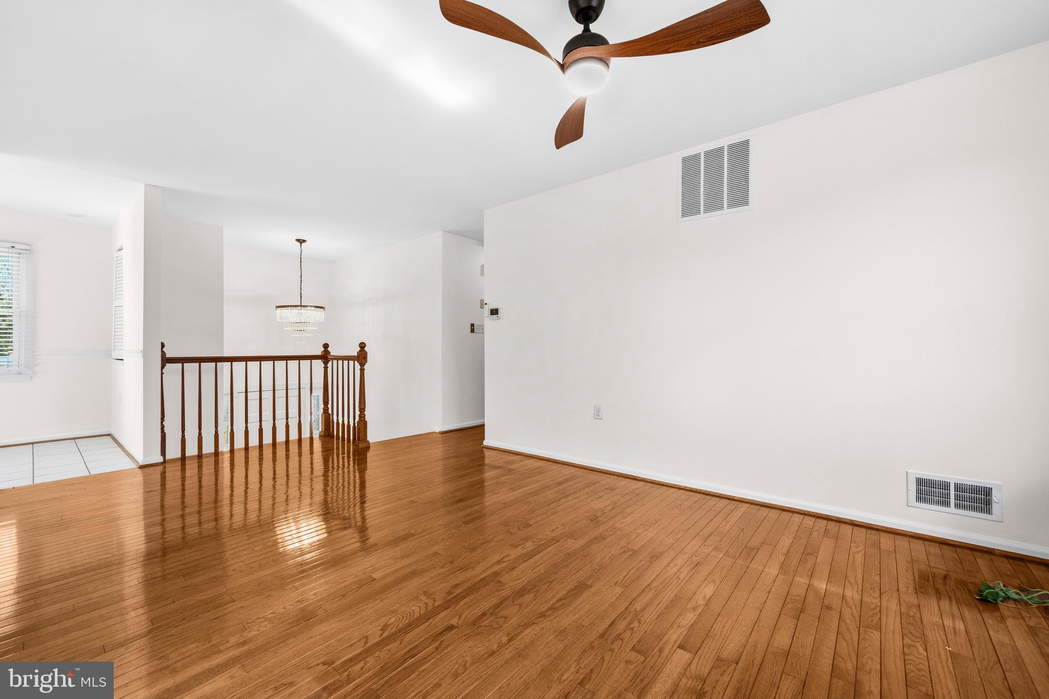 5 Coatbridge Court Olney, MD 20832 - Photo 9 of 49 an empty room with wooden floor ceiling fan and windows