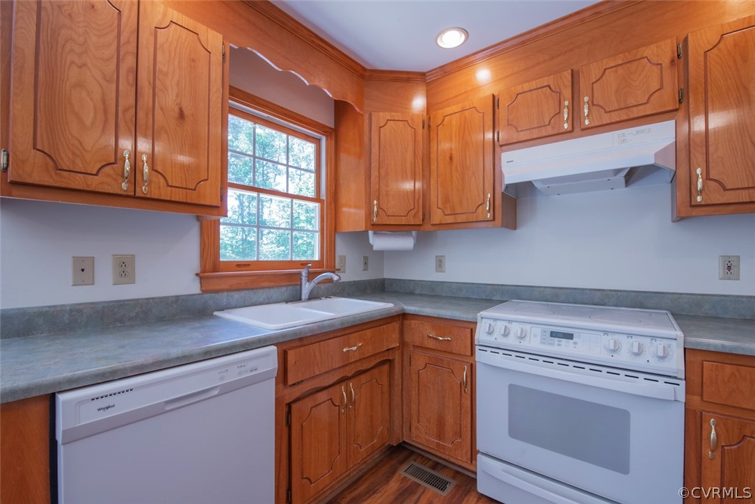 21417 Courthouse Road Dinwiddie, VA 23841 - Photo 22 of 50 a kitchen with stainless steel appliances granite countertop a sink a stove and cabinets
