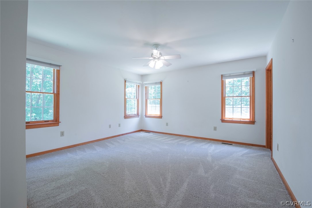 21417 Courthouse Road Dinwiddie, VA 23841 - Photo 33 of 50 an empty room with windows and chandelier fan